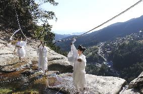 Sacred rope exchange at western Japan waterfall