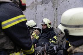 Firefighters Work At The Site Of A Russian Missile Strike, Amid Russia's Attack  December 29, 2023.