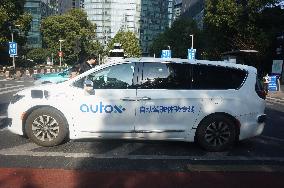 A Driverless Taxi RoboTaxi Runs on A Road in Hangzhou