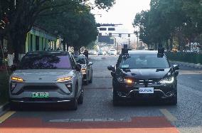 A Driverless Taxi RoboTaxi Runs on A Road in Hangzhou