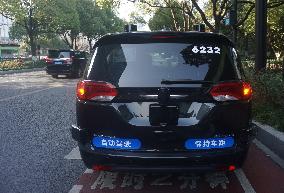 A Driverless Taxi RoboTaxi Runs on A Road in Hangzhou