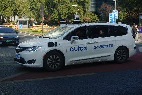 A Driverless Taxi RoboTaxi Runs on A Road in Hangzhou