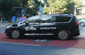 A Driverless Taxi RoboTaxi Runs on A Road in Hangzhou