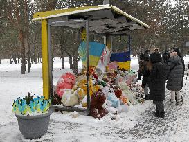 Memorial outside Dnipro apartment block ruined by Russian troops