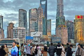 Tourists Enjoy the Bund and Nanjing Road in Shanghai