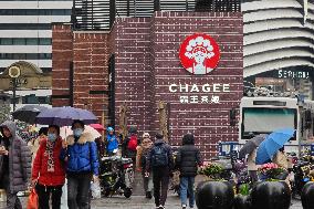 People Walk Past A CHAGEE Store in Shanghai