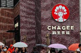 People Walk Past A CHAGEE Store in Shanghai