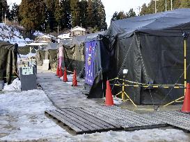 Temporary bathing facility in quake-hit city