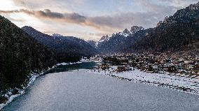 Drone View Of Santa Caterina Lake (Auronzo Lake) At Sunset With Frozen Water