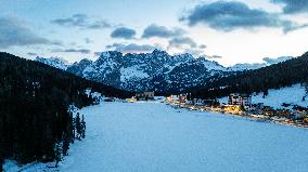 Drone View of Frozen Lake Misurina Covered in Snow At Sunset