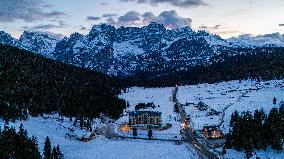 Drone View of Frozen Lake Misurina Covered in Snow At Sunset
