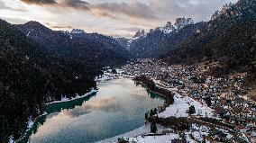 Drone View Of Santa Caterina Lake (Auronzo Lake) At Sunset With Frozen Water