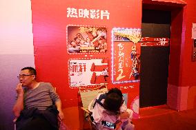 People Wait in Front of Movie Posters for the Lunar Year at A Cinema in Nanning