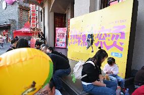 People Wait in Front of Movie Posters for the Lunar Year at A Cinema in Nanning