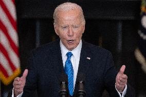 US President Joe Biden delivers remarks in the State Dining Room of the White House