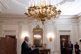 US President Joe Biden delivers remarks in the State Dining Room of the White House