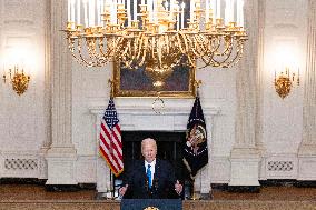 US President Joe Biden delivers remarks in the State Dining Room of the White House