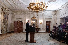 US President Joe Biden delivers remarks in the State Dining Room of the White House