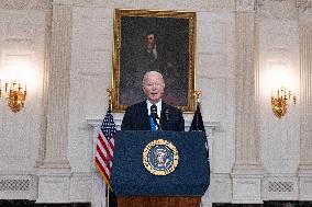 US President Joe Biden delivers remarks in the State Dining Room of the White House