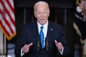 US President Joe Biden delivers remarks in the State Dining Room of the White House