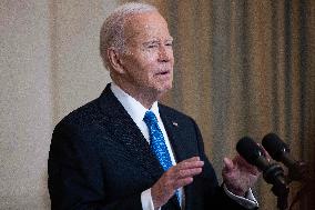 US President Joe Biden delivers remarks in the State Dining Room of the White House