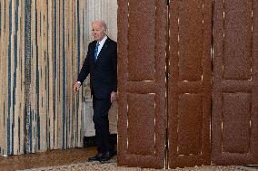 US President Joe Biden delivers remarks in the State Dining Room of the White House