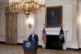 US President Joe Biden delivers remarks in the State Dining Room of the White House