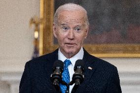 US President Joe Biden delivers remarks in the State Dining Room of the White House