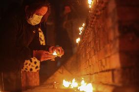 Family Members Of Deceased Nepali Citizen While Fighting For Russia Lights Lamp During A Vigil Ceremony Held In Kathmandu.