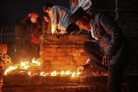 Family Members Of Deceased Nepali Citizen While Fighting For Russia Lights Lamp During A Vigil Ceremony Held In Kathmandu.