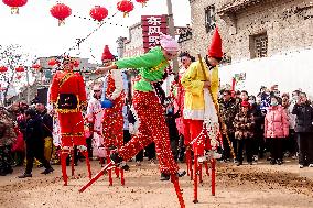 People Walk on Stilts to Celebrate Lantern Festival