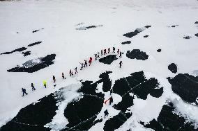 Enthusiasts Hike at Snow-covered Jinlong Lake in Karamay