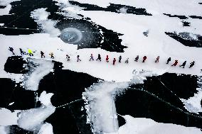 Enthusiasts Hike at Snow-covered Jinlong Lake in Karamay