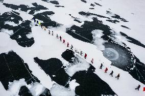 Enthusiasts Hike at Snow-covered Jinlong Lake in Karamay