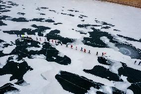 Enthusiasts Hike at Snow-covered Jinlong Lake in Karamay