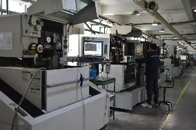 Workers Operate Wire-cut CNC Machine Tools in Fuyang