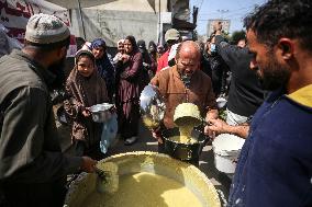 Humanitarian Aid in Gaza: Palestinians Receive Food Rations Amid Conflict