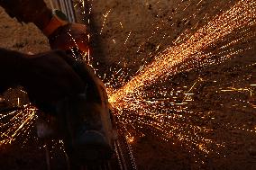 Worker Cutting Iron - India