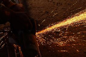 Worker Cutting Iron - India