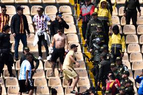 Fans of Deportes Tolima Clash with Santa Fe Fans during Match
