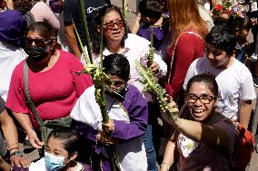Catholic Devotees Bless Their Palm Branches During The Palm Sunday