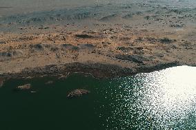 Arid Yadan Landscape and A Moist Lake in Gobi Desert in Hami