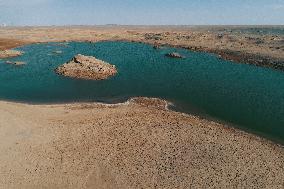Arid Yadan Landscape and A Moist Lake in Gobi Desert in Hami