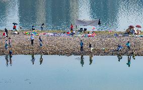 Tourists Play on The Yangtze River Beach in Chongqing