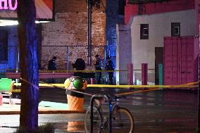 Two People Shot As They Stood On A Sidewalk; One In Critical Condition
