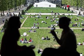 People enjoying the sun in Paris