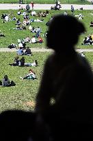 People enjoying the sun in Paris