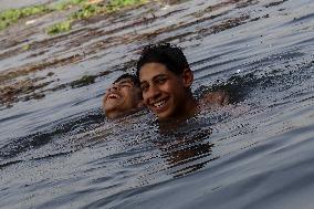 Egyptians Escape The Heat In The Nile River