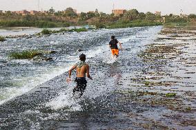 Egyptians Escape The Heat In The Nile River