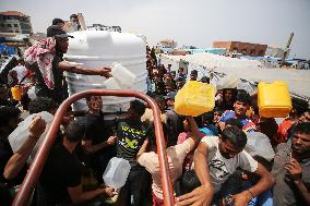 Palestinians Queue for Water in Gaza Amid Hamas-Israel Conflict